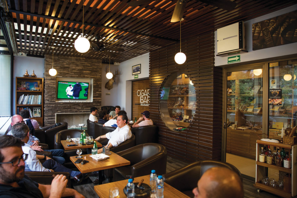 Cigar Bar Delegados in Polanco is a terrace lounge with a red phone booth entrance