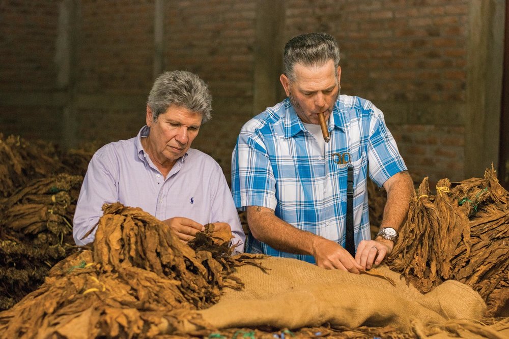 Aganorsa founder Eduadro Fernández (left) and Illusione founder Dion Giolito inspect Aganorsa tobacco together in Estelí.