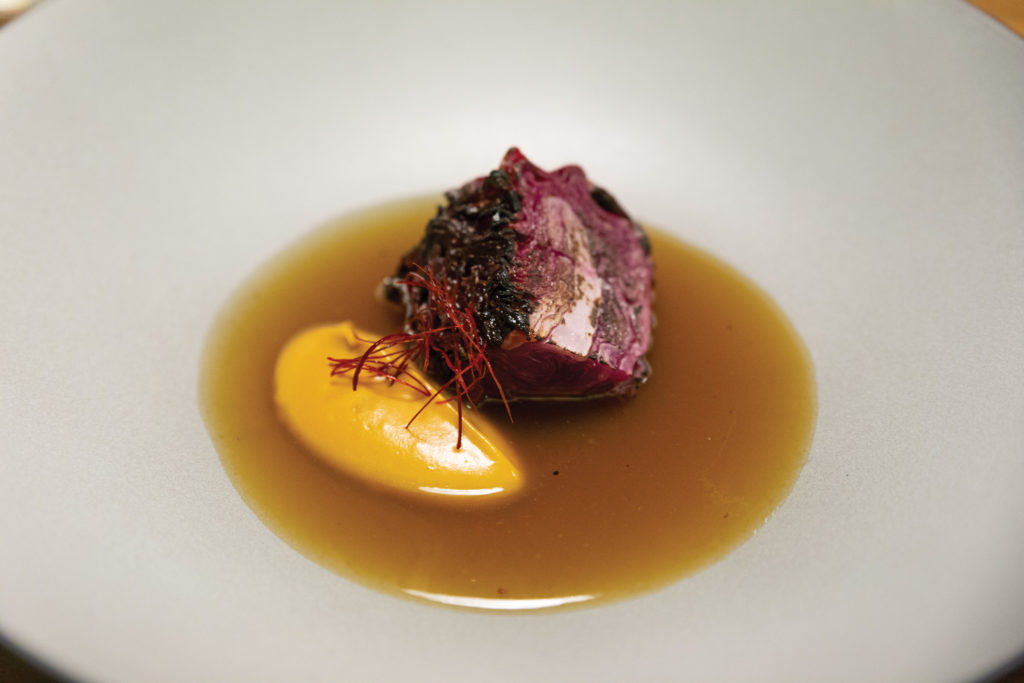 Dishes on the tasting menu at Quintonil (roasted cabbage with a creamed scallop)