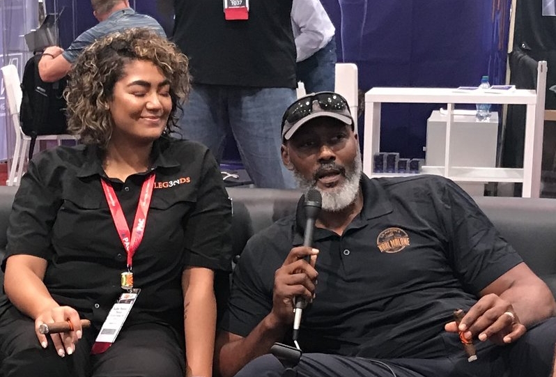  Karl Malone talks about his new cigar — Barrel-Aged by Karl Malone — with his daughter Kadee, who is co-owner of Legends Cigar and Vape in Ruston, Louisiana. 