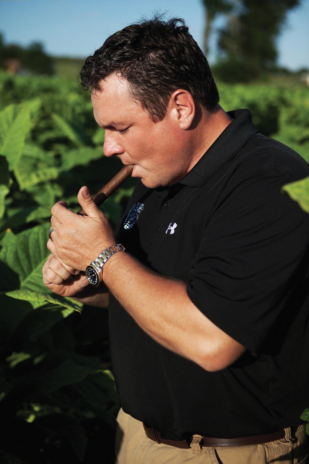  Jeff Borysiewicz smokes a cigar among the tobacco at his Florida Sun Grown tobacco farm in Central Florida.  (image: Zach Ramsey)  