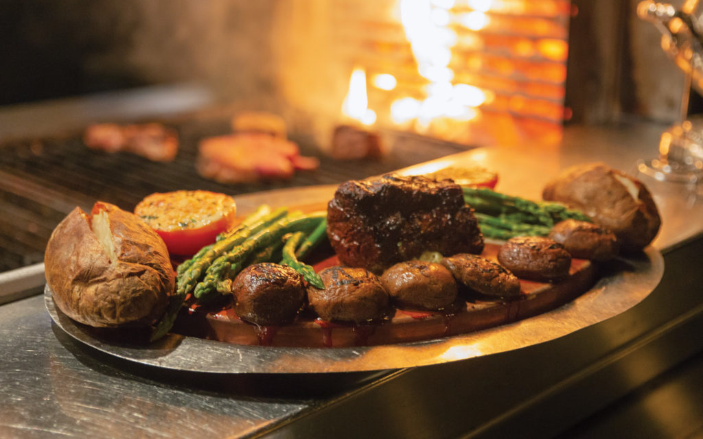 steaks are cooked over charcoal at El Gaucho